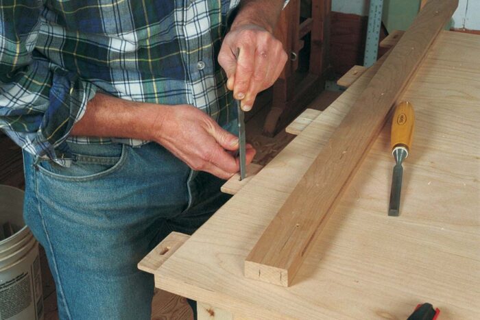 No glue in the long holes. The center tenon has a round hole, which will get glued and pegged during assembly.