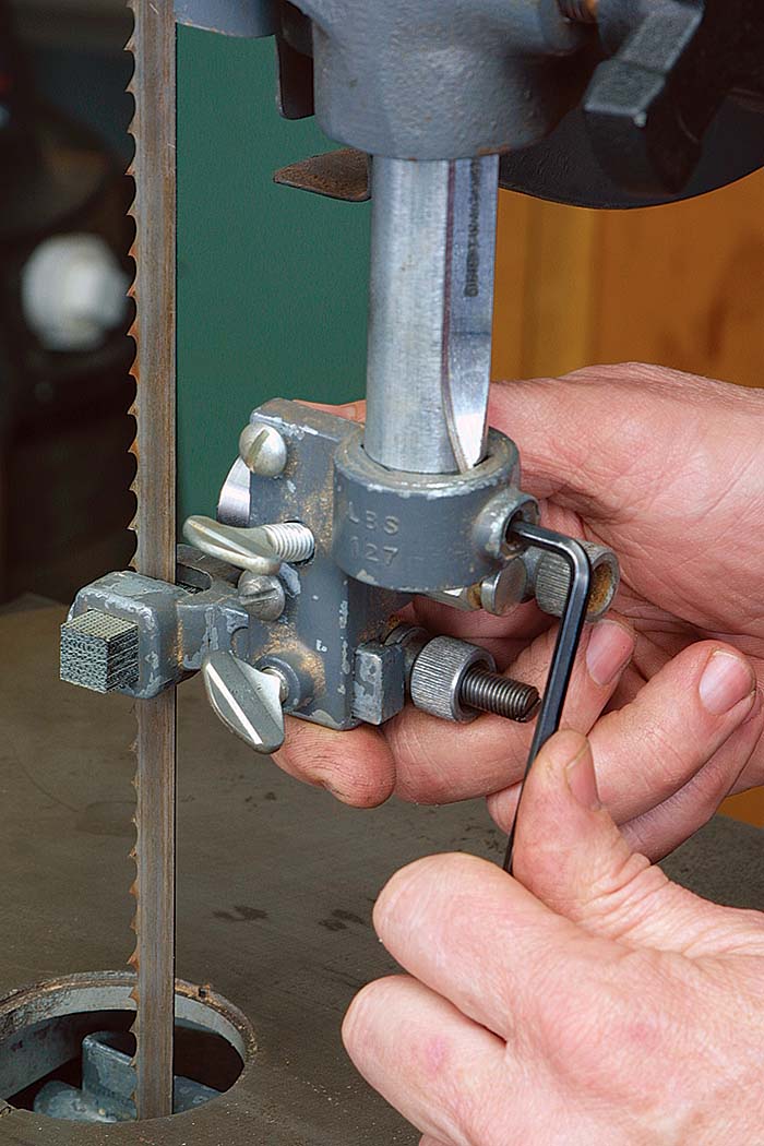 Loosen the Allen screw on the upper guide assembly 