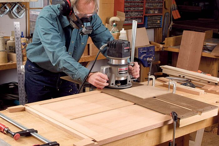 Dovetails and dadoes with one jig. A router outfitted with a guide collar rides in a long jig placed squarely across the cabinet side.