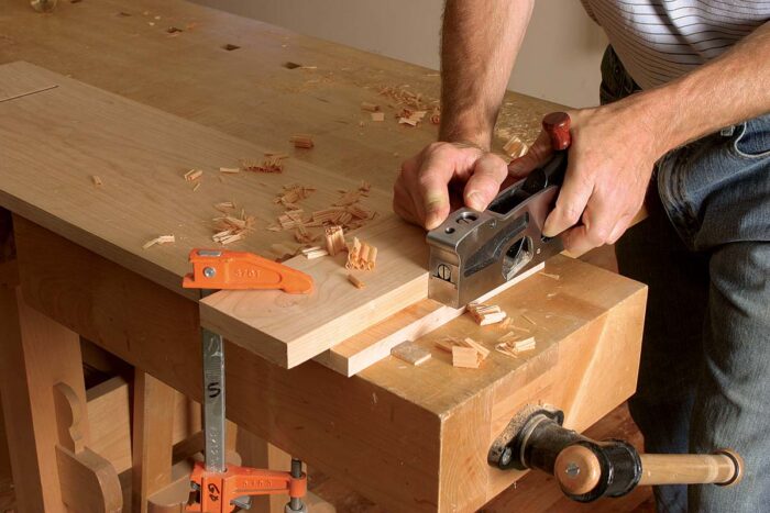 clamp a wood straightedge to the workpiece and start cutting