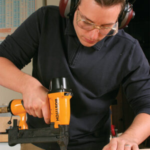 man wearing hearing protectors while using tool