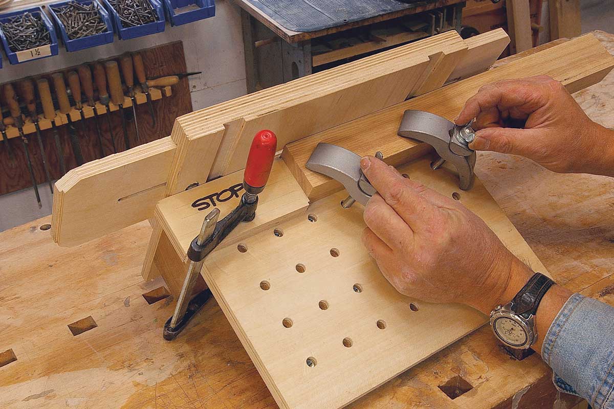 Clamp the piece to the jig. Center the mortise in the viewing port and tighten the hold-down clamps. If more than one piece is being cut, a stop block aids repeatability.