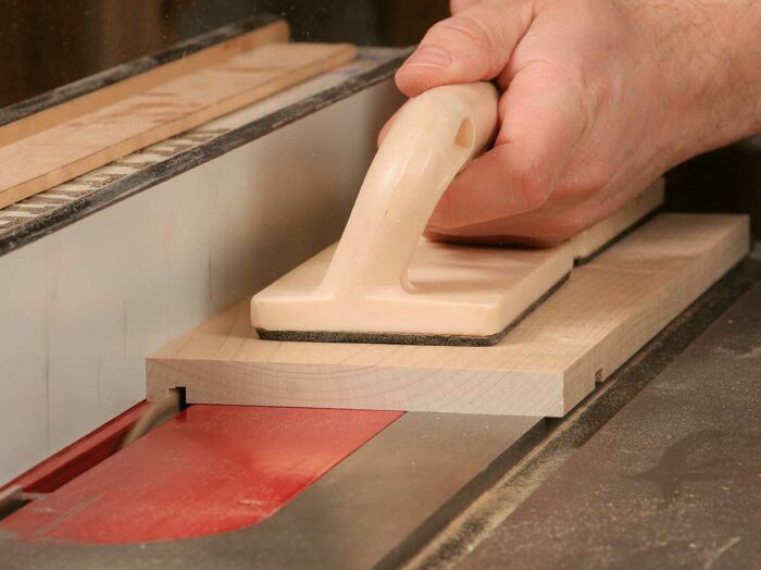 Use a standard blade for the groove. Stacking a dado cutter to match the thickness of the plywood bottom is a fussy task; two passes over a combination blade cuts the groove quickly.