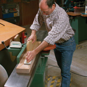 walk the board forward with hands in place on the jointer