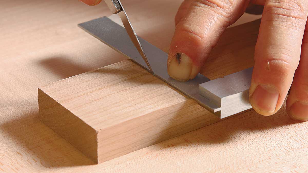 Mark the shoulder. Use a square and knife to get a clean, deep (1⁄16 in.) cut across the grain. The width of the mating part determines the shoulder’s location.