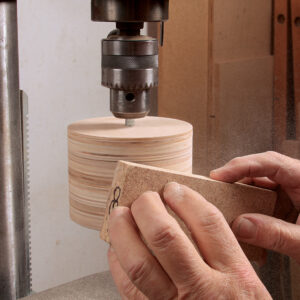 chuck the drum in the drill press and smooth it