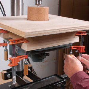 raise the drill press and clamp the sanding table in place