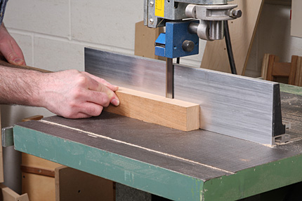 Matt pushes a long piece of lumber through a bandsaw, taking a thin cut to be used for shop-sawn veneer.