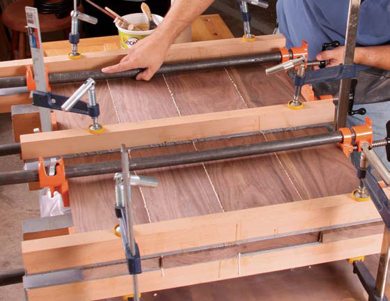 applying edge clamps to draw wooden boards together