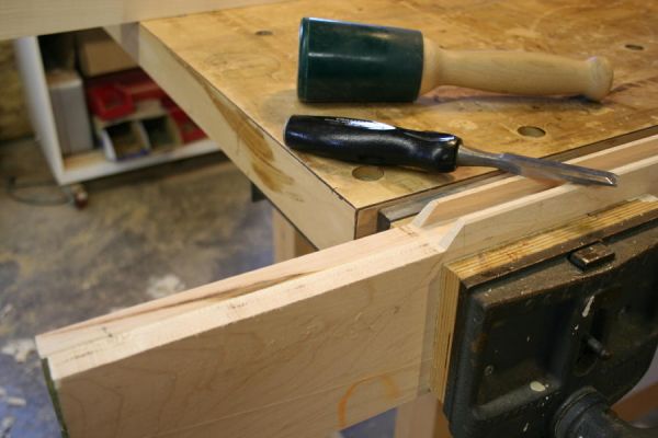 putting miters on the interior corners of a frame and panel door by hand; miters with a chisel