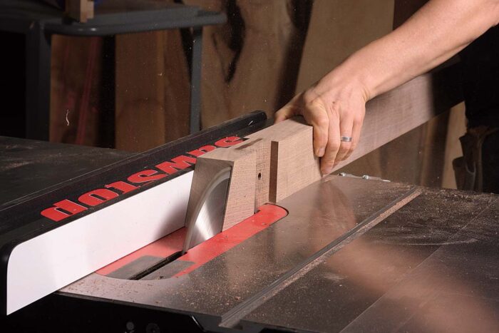 After cutting the angle on each end of the stretcher on the miter saw, use the tablesaw to trim the block beyond the half lap. With the blade fully raised, rip in and back out