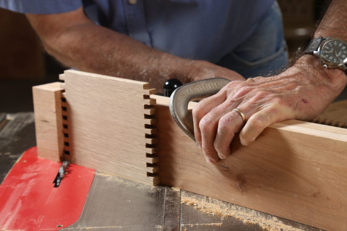 clamp the stop—a hook fence in this case—to the miter gauge