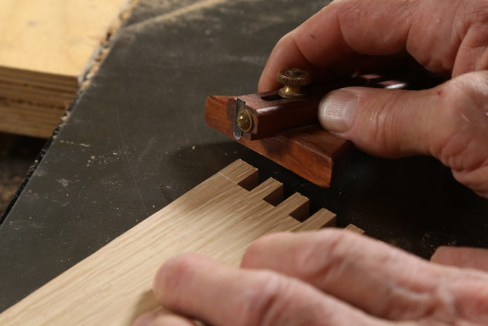 using a marking gauge to delineate the inside shoulder of the fingers
