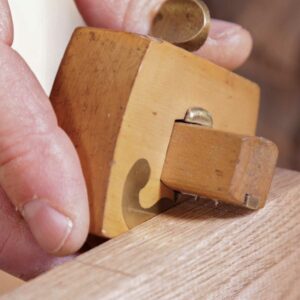 Scribe the mortise walls. Run the gauge between the end lines of the mortise on each edge of the stock. Make sure to reference off the show face.