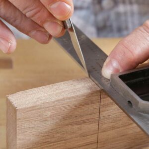 Lay out the tenon shoulders. The length of the tenon should equal the width of the stile. Use a knife and square to wrap the shoulder line around the piece.