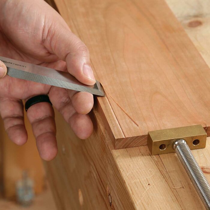 Cut a shoulder. After laying out the rabbet’s width with a marking gauge, use a chisel to cut down toward the line at an angle. This creates a shoulder to guide the plane.
