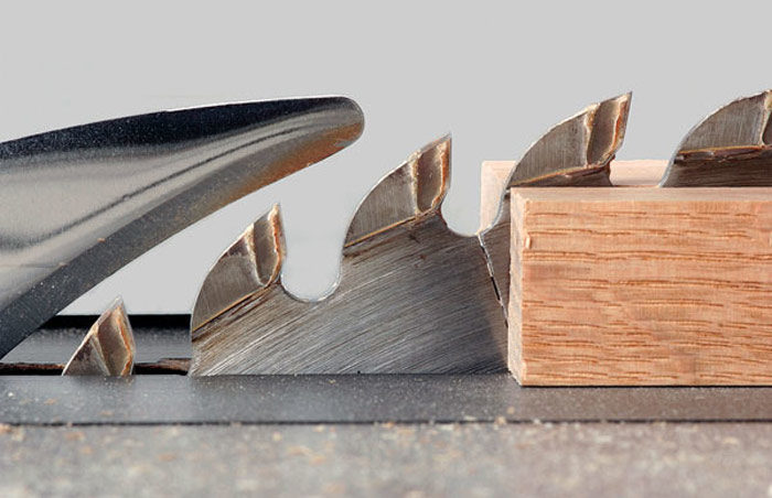 Tablesaw blade cutting through wood