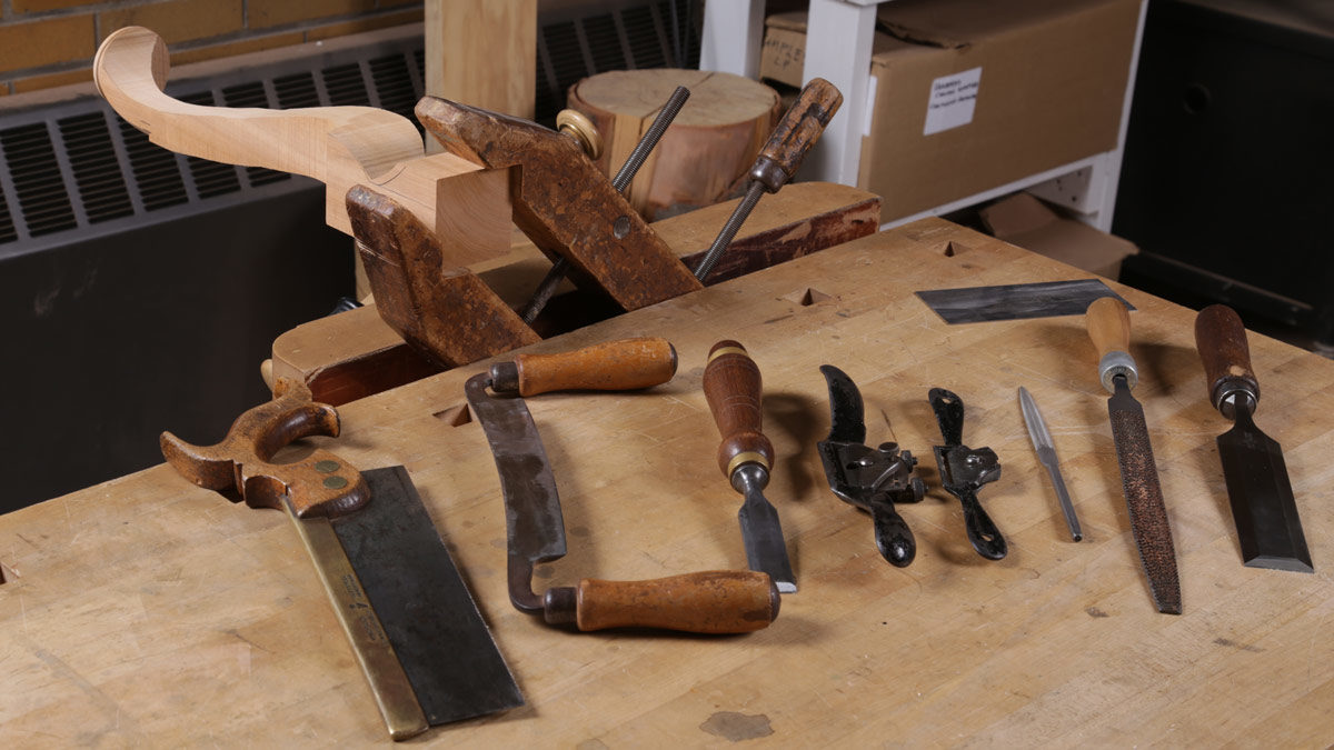 A backsaw, drawknife, a couple of chisels, spokeshaves, files, and of course, a card scraper.