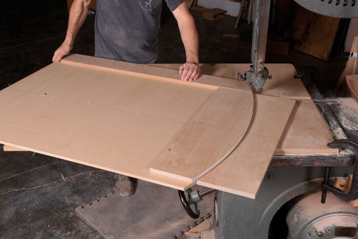 one sheet of MDF clamped to the bandsaw table and fitted with a metal pin, another sheet is laid on top and pivots on the pin