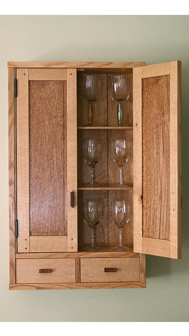 Cabinet open with wine glasses on shelves