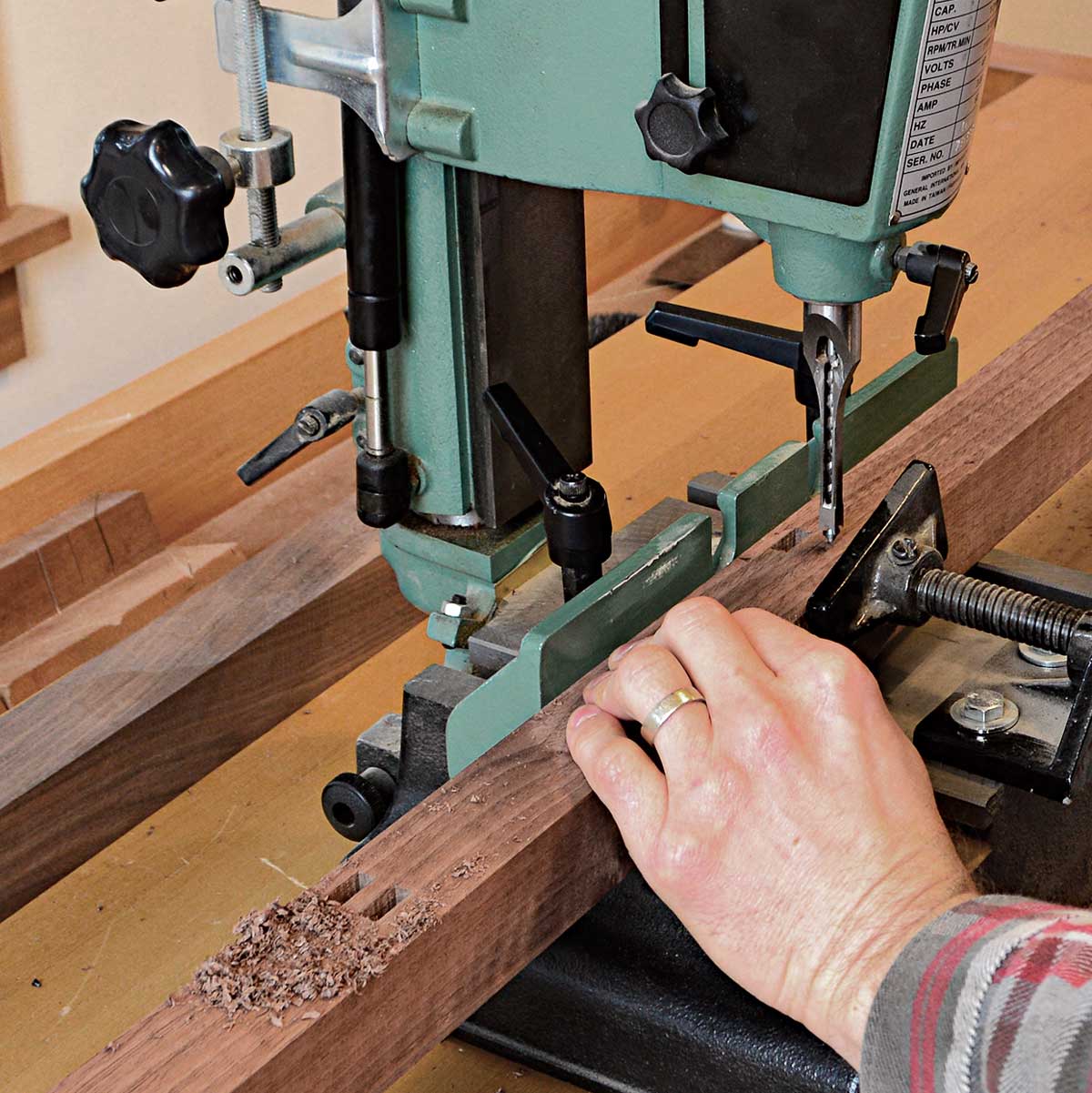 With double tenons, consistent mortise spacing is key. Korsak cuts one mortise of each pair, then shifts the mortiser’s fence to cut all the second mortises.