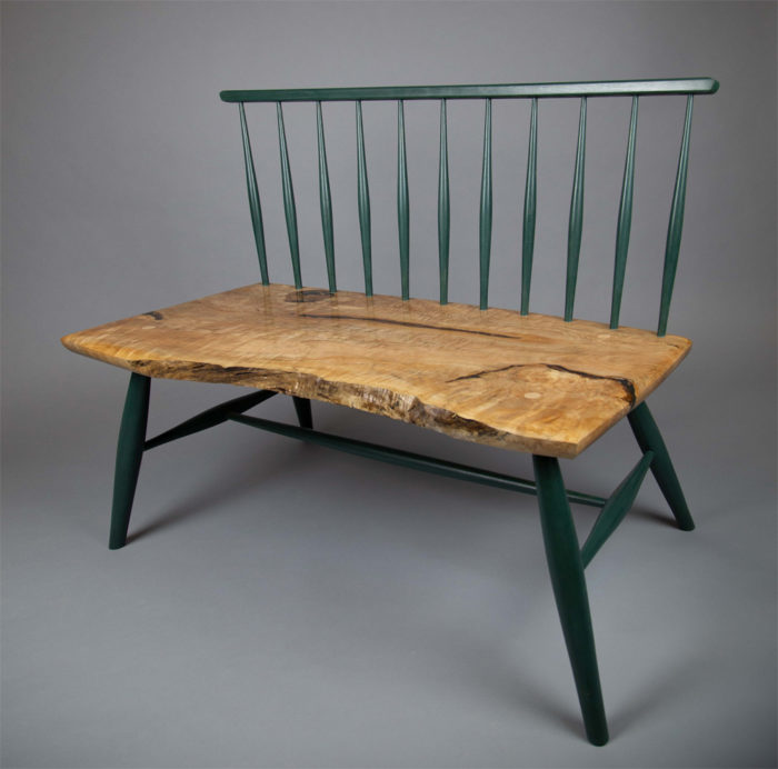 wooden bench with green accents 