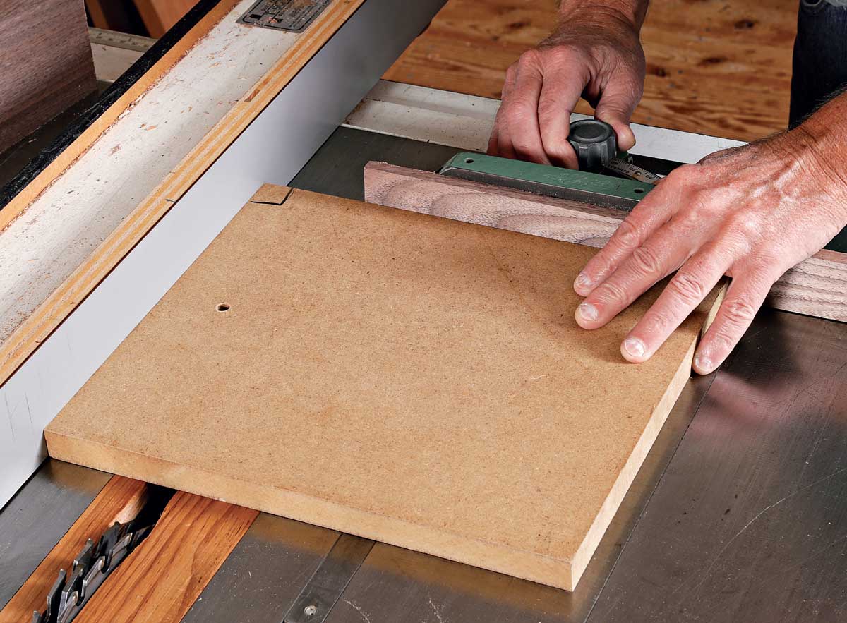 Square up the miter gauge. Durfee uses a piece of MDF with a square corner for the job. Hold the MDF against the tablesaw fence and the miter gauge, and adjust the miter gauge until it is flush with the back edge of the MDF. Make a test cut to check the setup.