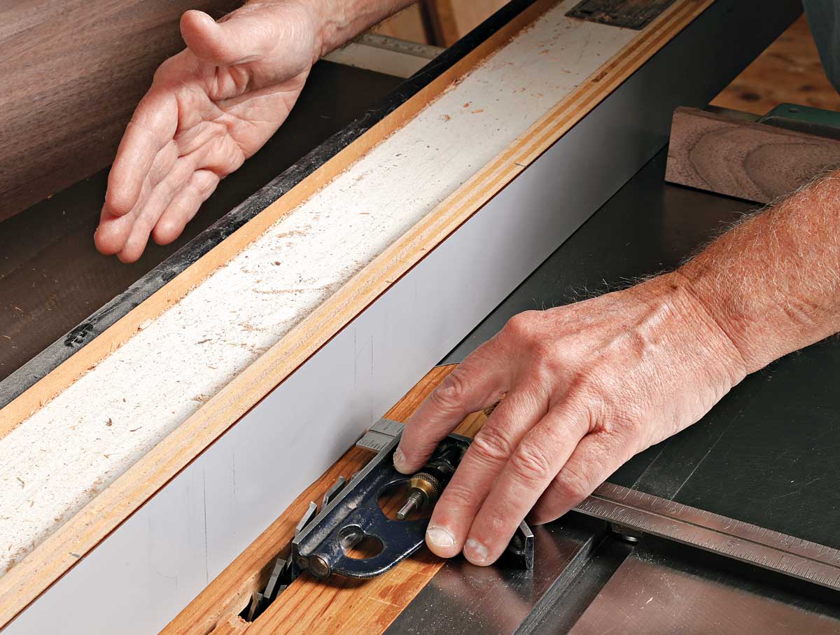 Set the tenon length. When cutting tenons, Durfee uses the tablesaw’s rip fence as a stop. Use a combination square as shown, and measure from the outside of the dado set. Slide the fence until it touches the end of the rule.