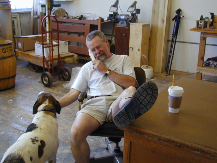 Phil Lowe sitting down petting a dog
