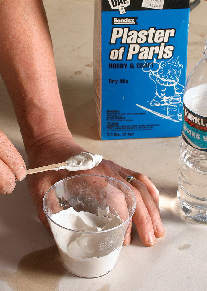 Man making a plaster of paris mixture.