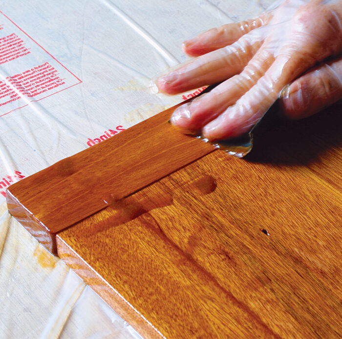 Sanding the varnish with the grain creates a slurry