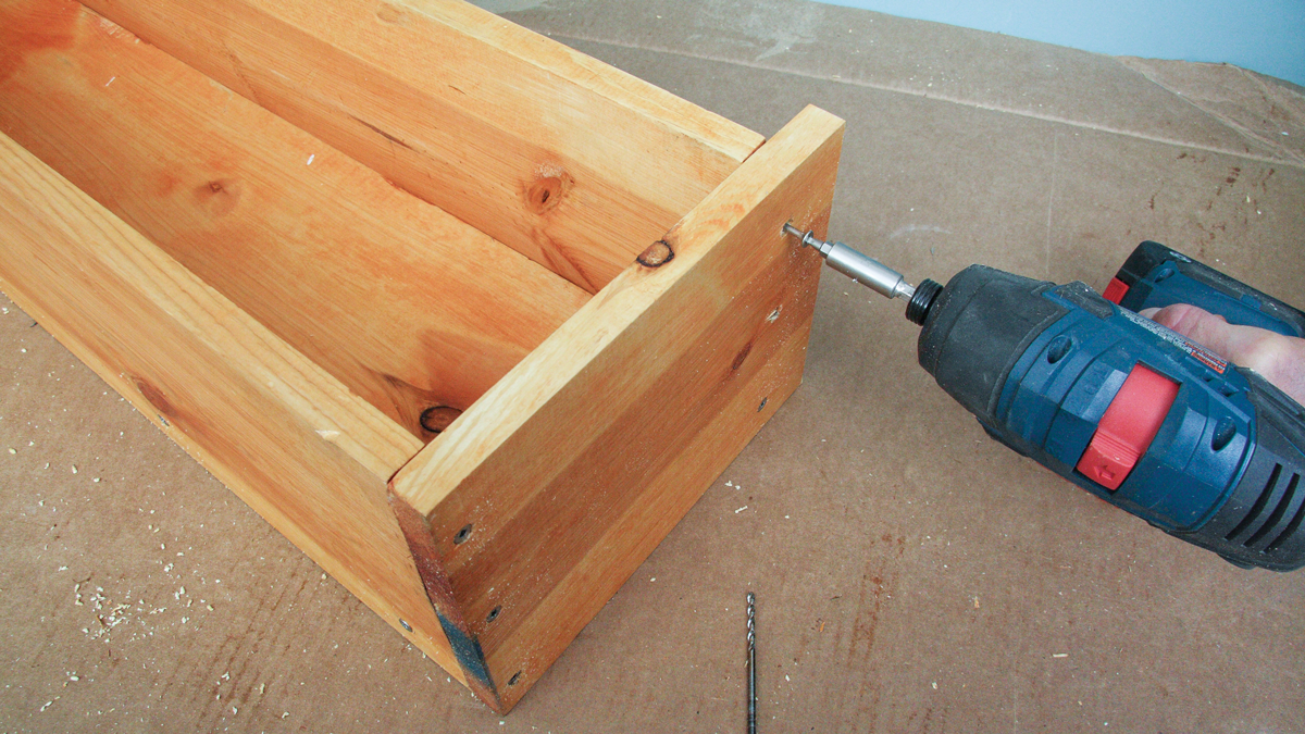 Attach the sides by drilling pilot holes and driving screws.