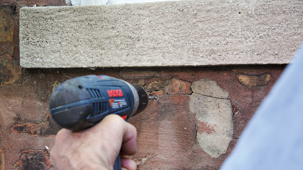 Remove the cleat and finish drilling the holes in the brick.