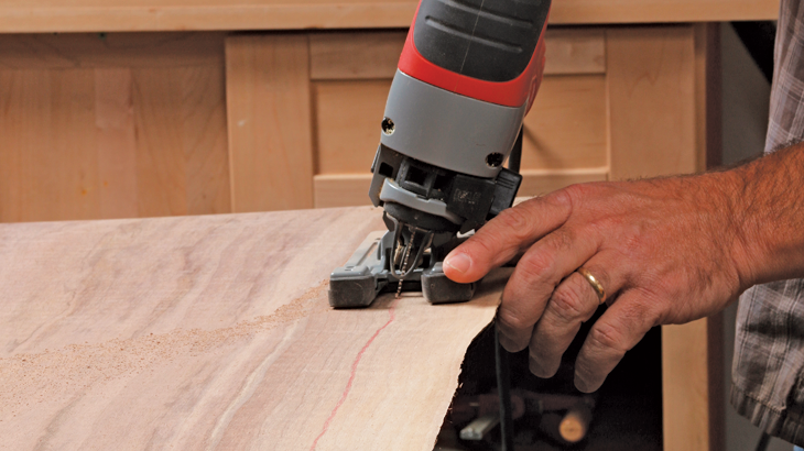 Just draw a line along one of the grain lines, angle your jigsaw blade to the new angle you want, and cut along the line.