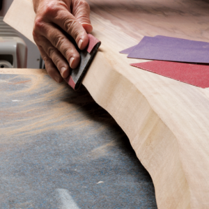 On the end grain, you’ll need to get rid of the burn marks from the saw by starting with rough sandpaper.