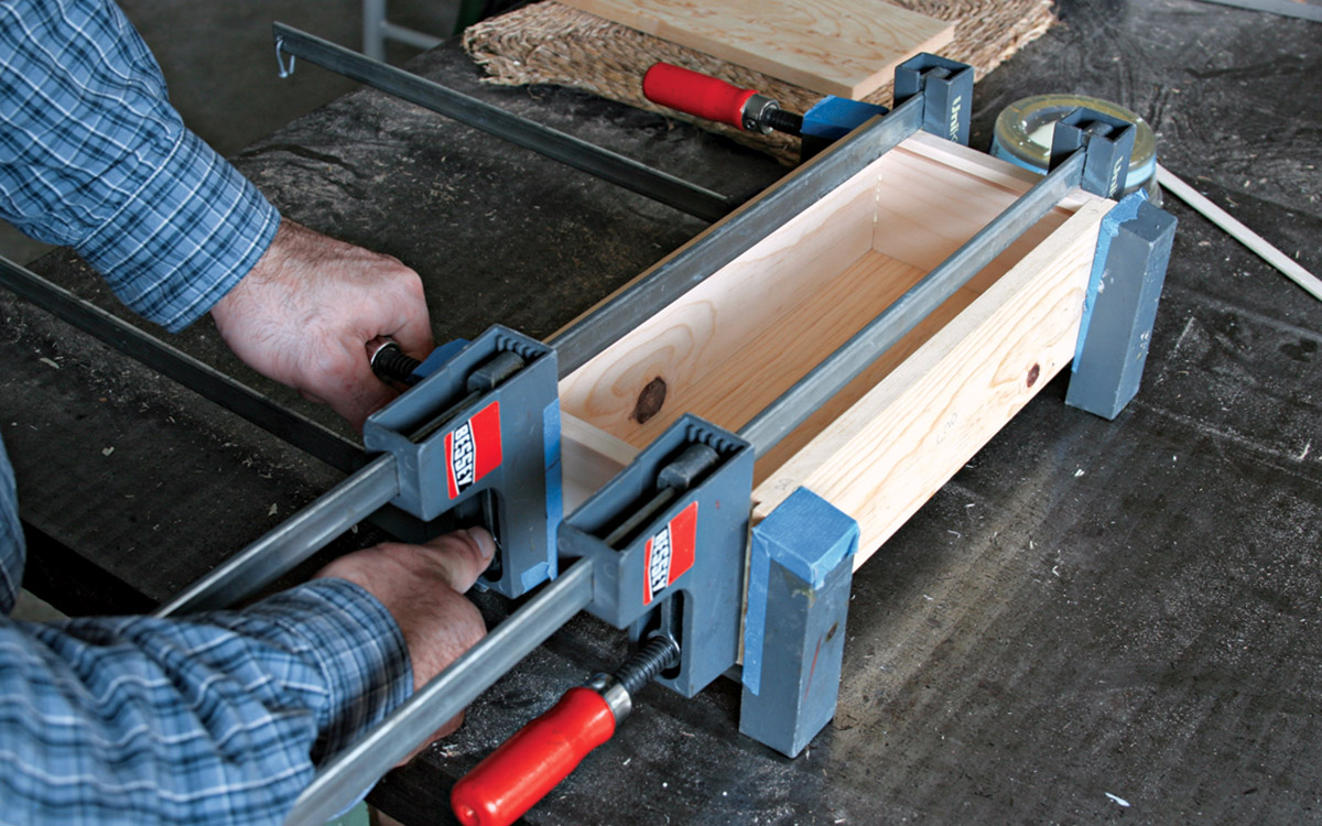 Apply clamps across the length and the width of the box