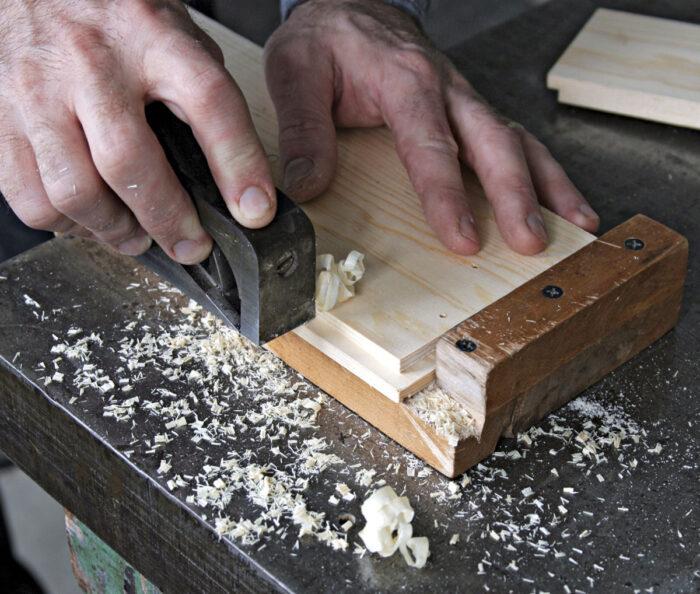 Trim the piece with a shoulder plane secured in place with a bench hook.