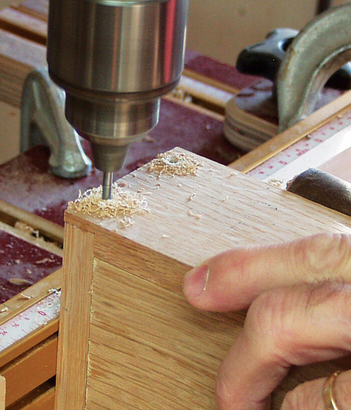 Drilling the corners of the box to accept dowels