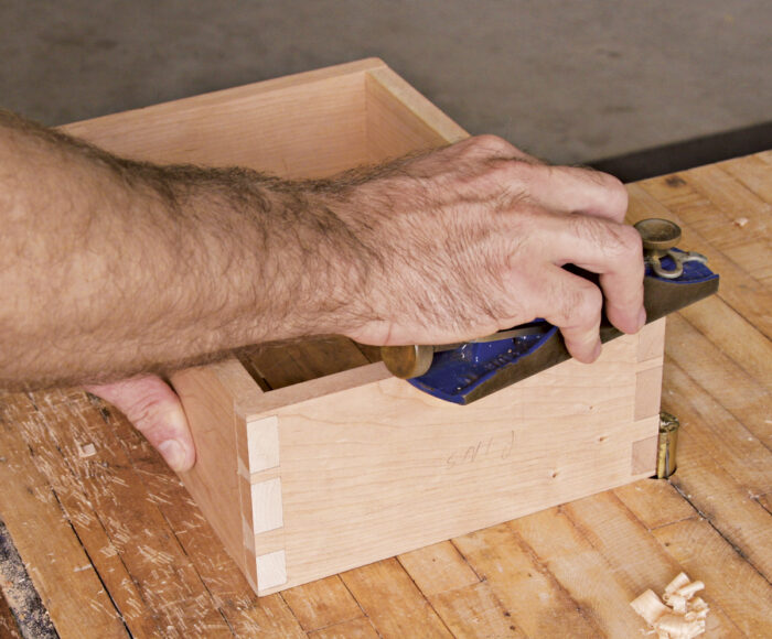 Use a blockplane or sand paper to trim the edges flush at the corners.
