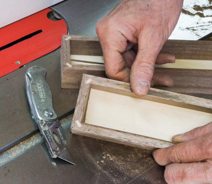 Finishing the cut with a utility knife and removing the remaining slivers of wood