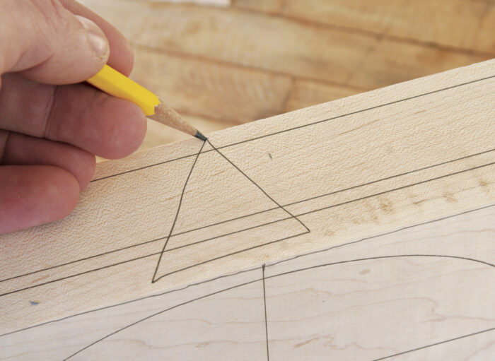 Make a triangle on the edge of the box as a guide to reassemble the box after it has been sawn apart.