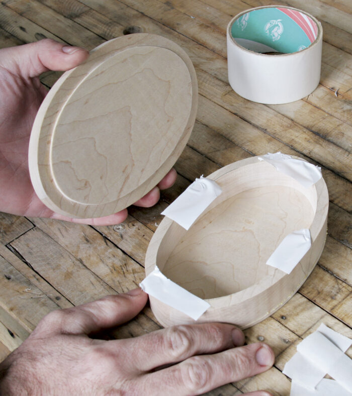 Use double-sided tape to secure the lid before sanding.