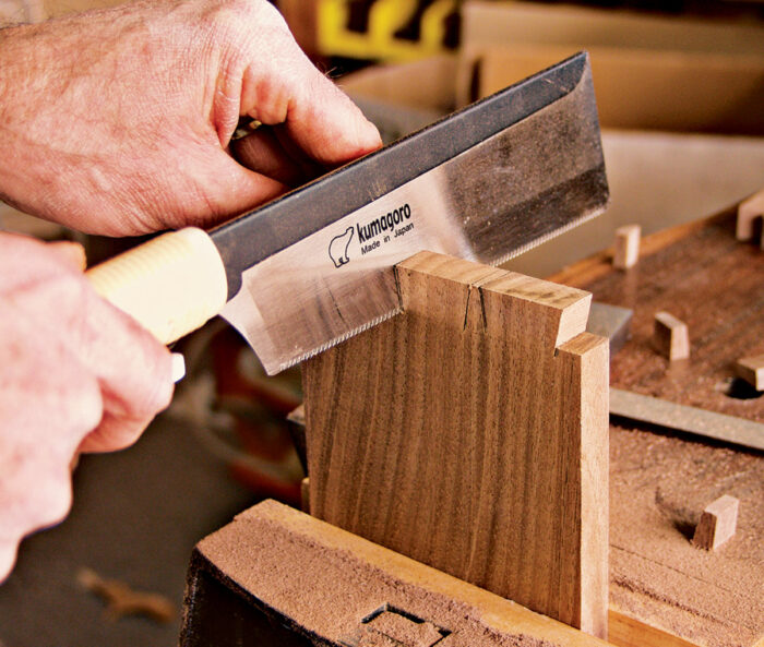 Using a dozuki saw or backsaw to make the angled cuts on the tails.