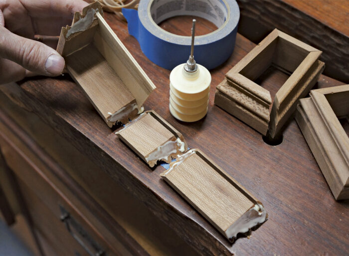 Roll the glued miters to complete the box while taped.