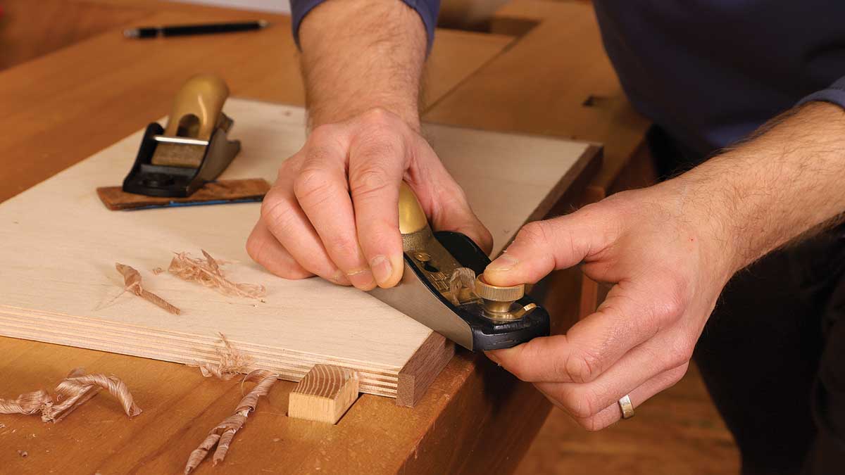 Using a second block plane, Korsak sets the cambered blade to take a very light cut