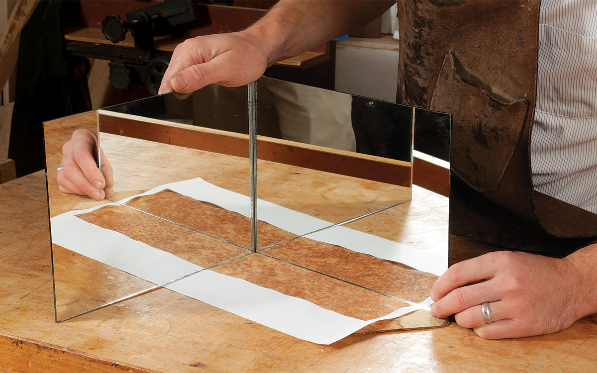 using mirrors to see where to cut veneer sheets