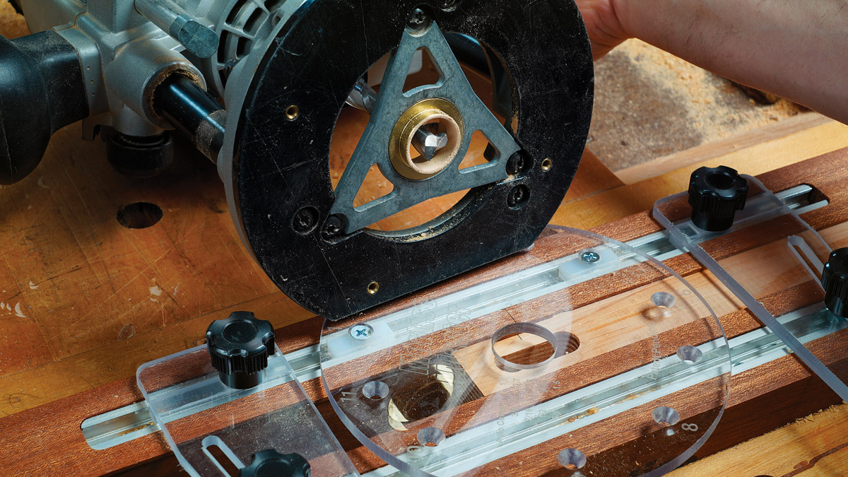 Fast and foolproof. The bushing fits in the jig’s slide plate with zero slop. UHMW plastic blocks attach to the plate for various mortise locations. The blocks slide nicely in the jig’s T-tracks for excellent control.