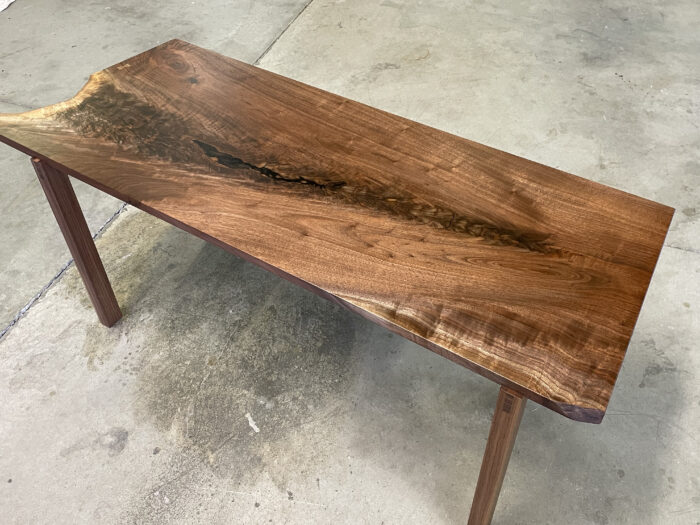 The finished product of a coffee table derived from a slab of walnut.