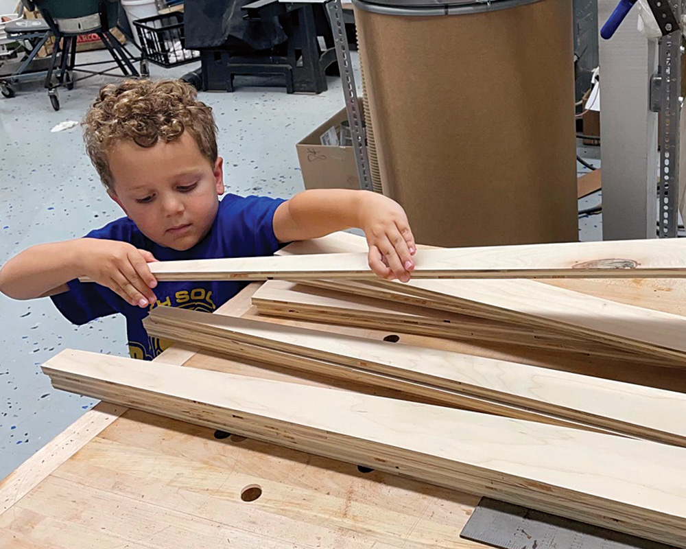 kid in a woodworking shop
