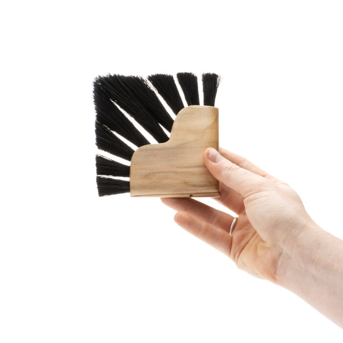 Brush with a heart shaped handle. The bristles are set and trimmed to make the overall shape of the brush a square profile.